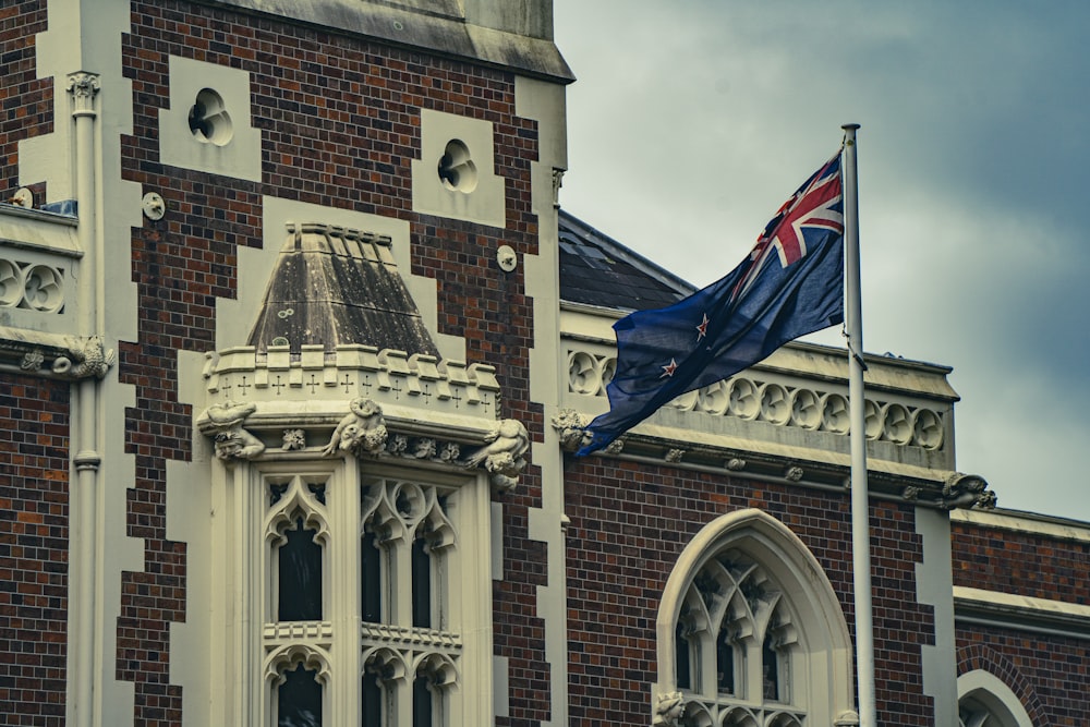 a british flag flying in front of a building