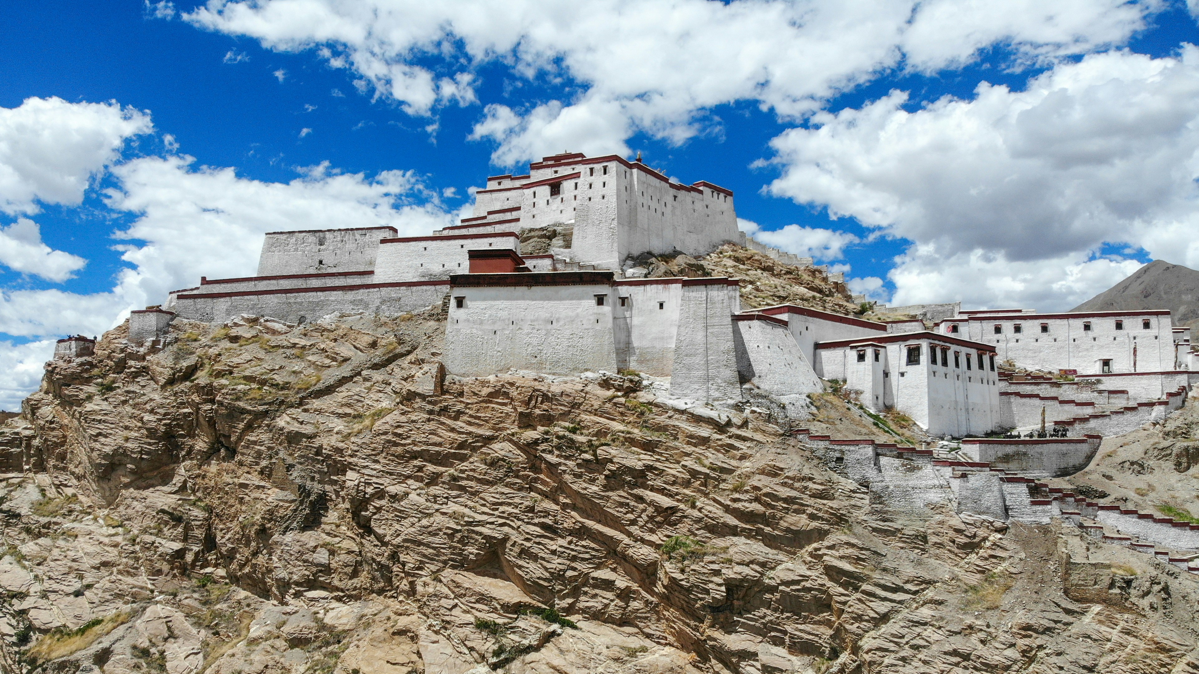 a large white building sitting on top of a mountain