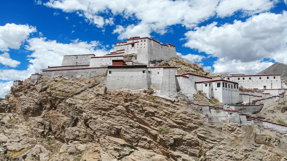 a large white building sitting on top of a mountain