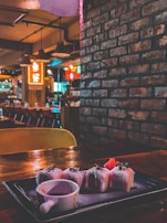 A cozy table setting inside Rainbow Sushi Inc with warm lighting and inviting decor.