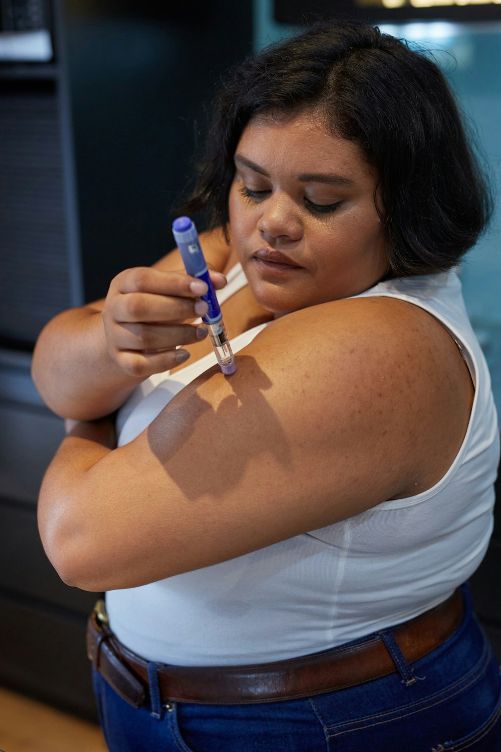 a woman holding a toothbrush in her right hand