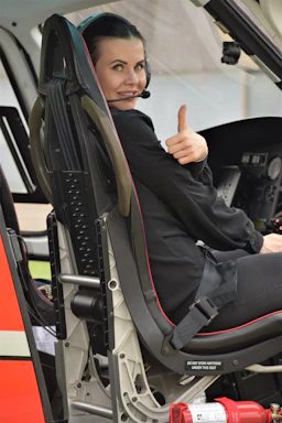 A friendly flight instructor smiling and ready to assist a student pilot.