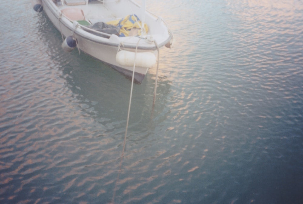 a small boat floating on top of a body of water