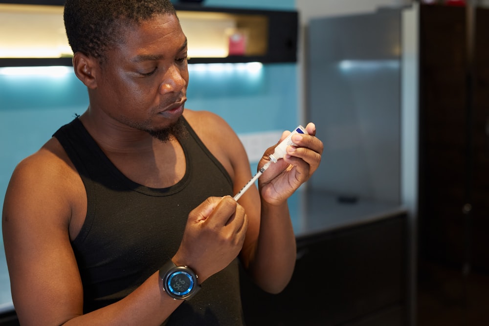 a man holding an insulin injection