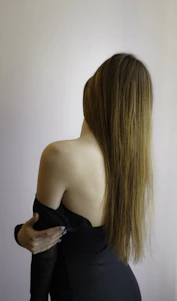 a woman in a black dress with long hair