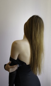 a woman in a black dress with long hair