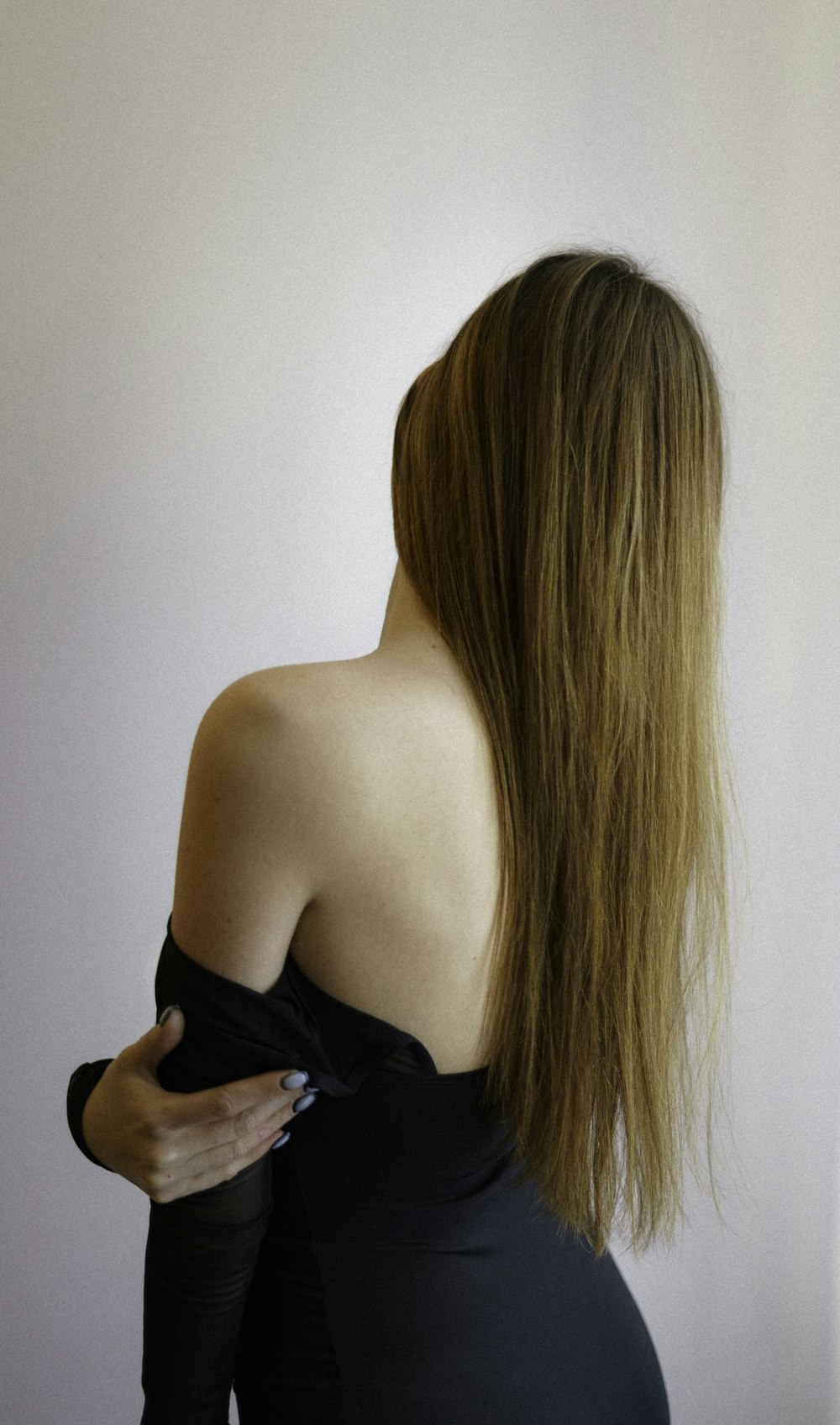 a woman in a black dress with long hair