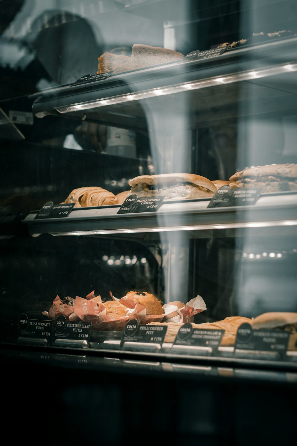 a bakery display case filled with lots of pastries