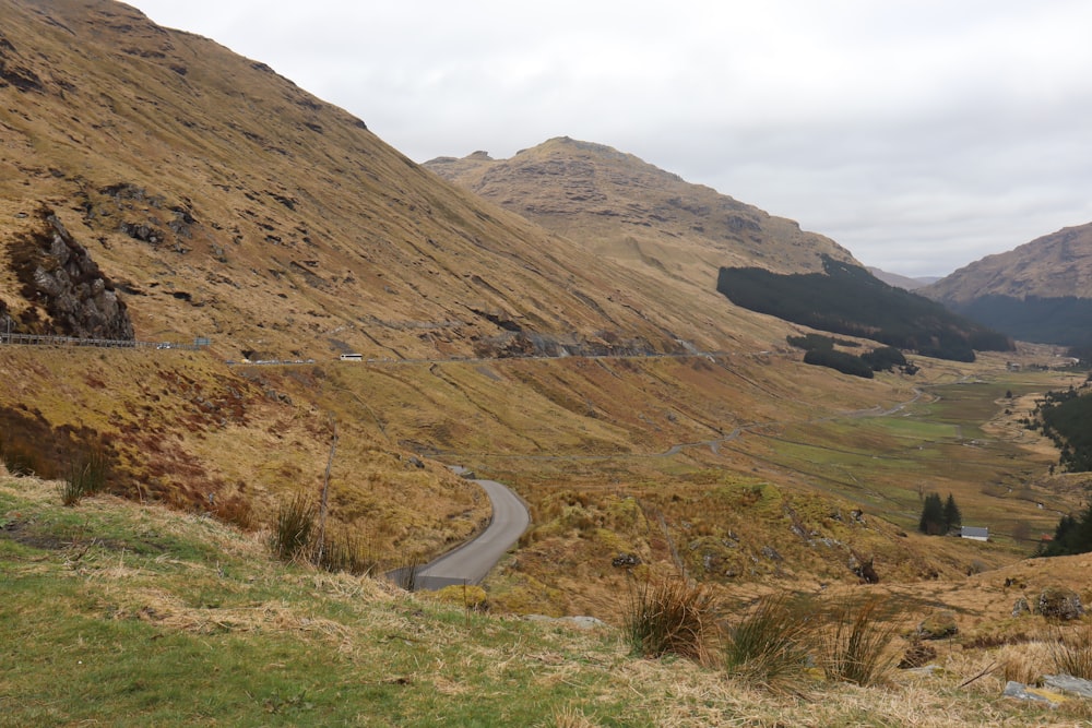 a winding road in the middle of a mountain range