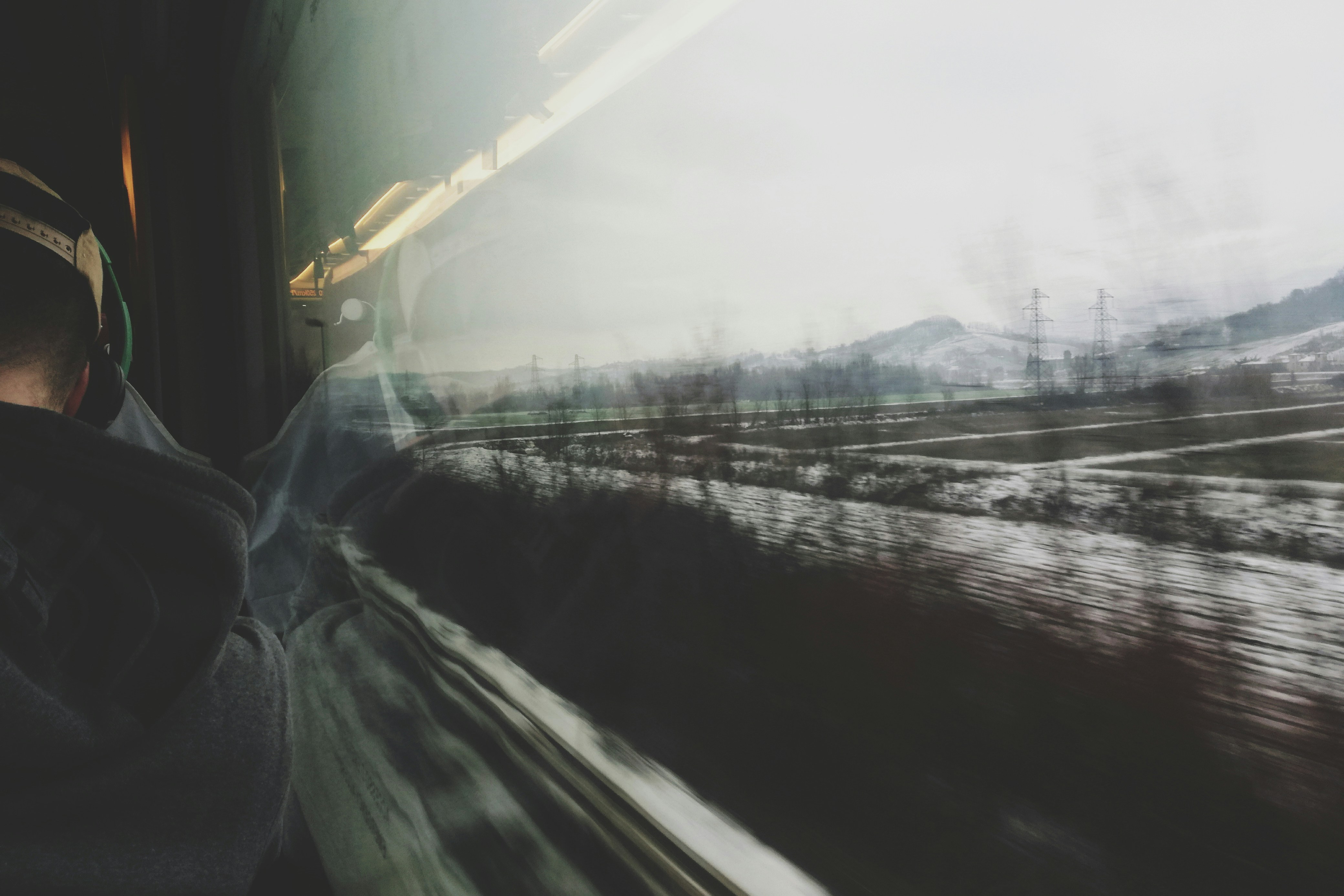 a blurry photo of a person looking out a train window