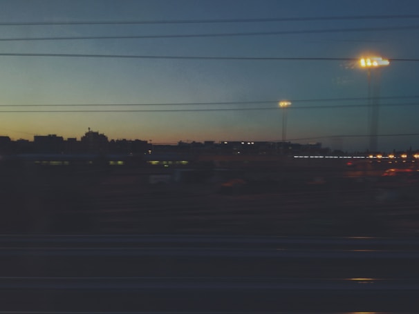 A cityscape at dusk with news headlines overlayed on the skyline.
