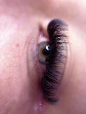 a close up of a person's eye with long eyelashes