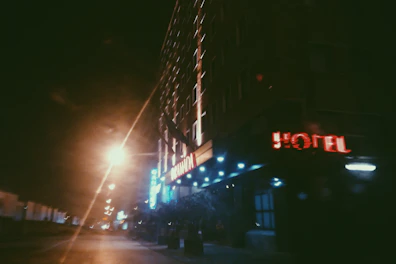 Night view of hotel illuminated with warm lights and cozy ambiance.