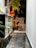 Photo of a warmly lit mudroom with a child and a dog playing safely on a tiled floor.