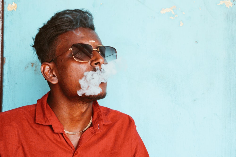 a man with sunglasses and a cigarette in his mouth
