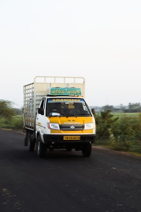 A friendly delivery truck on a sunny road, symbolizing quick and reliable transport services.
