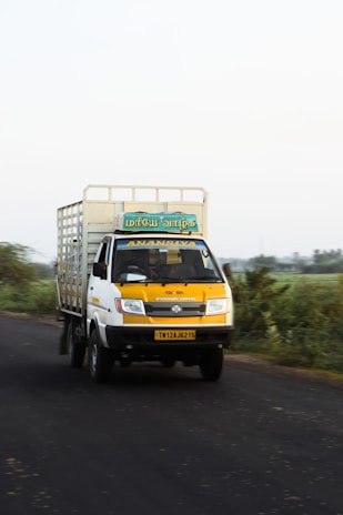 A friendly delivery truck on a sunny road, symbolizing reliable cargo transport.