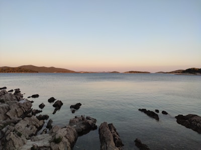 Dramatic sunrise over the protected marine zone highlighting rocky islands and calm waters.