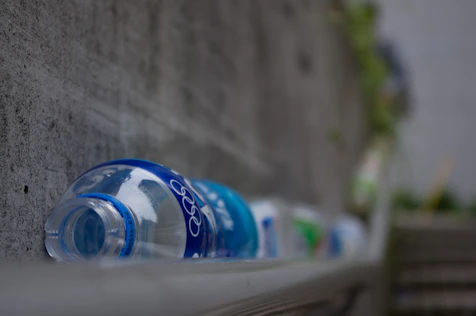 a row of water bottles sitting on the side of a building