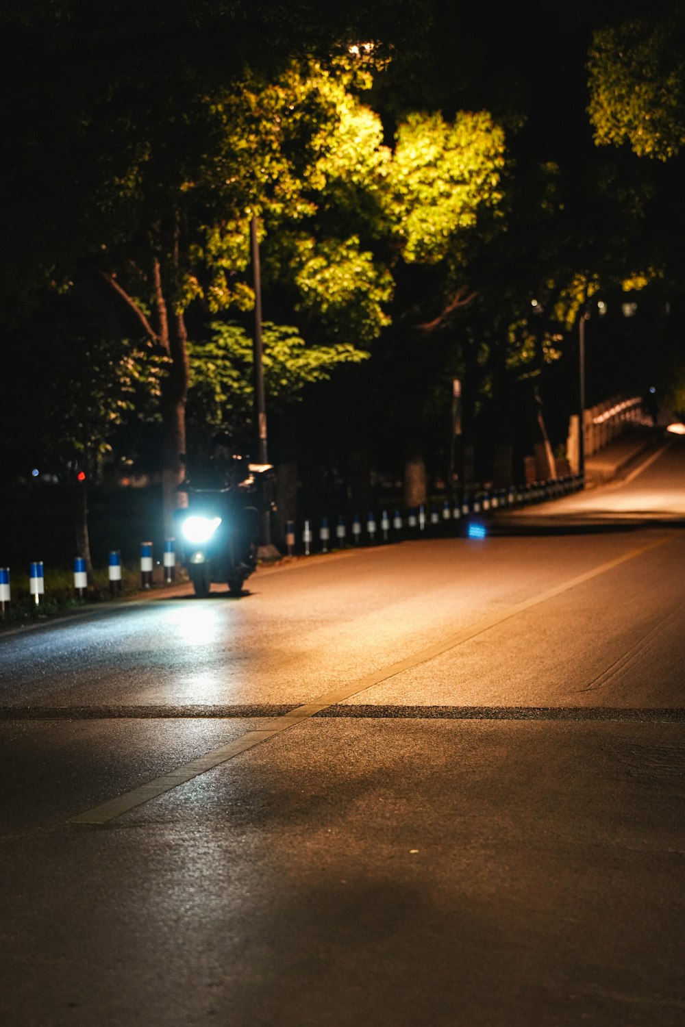 a car driving down a street at night