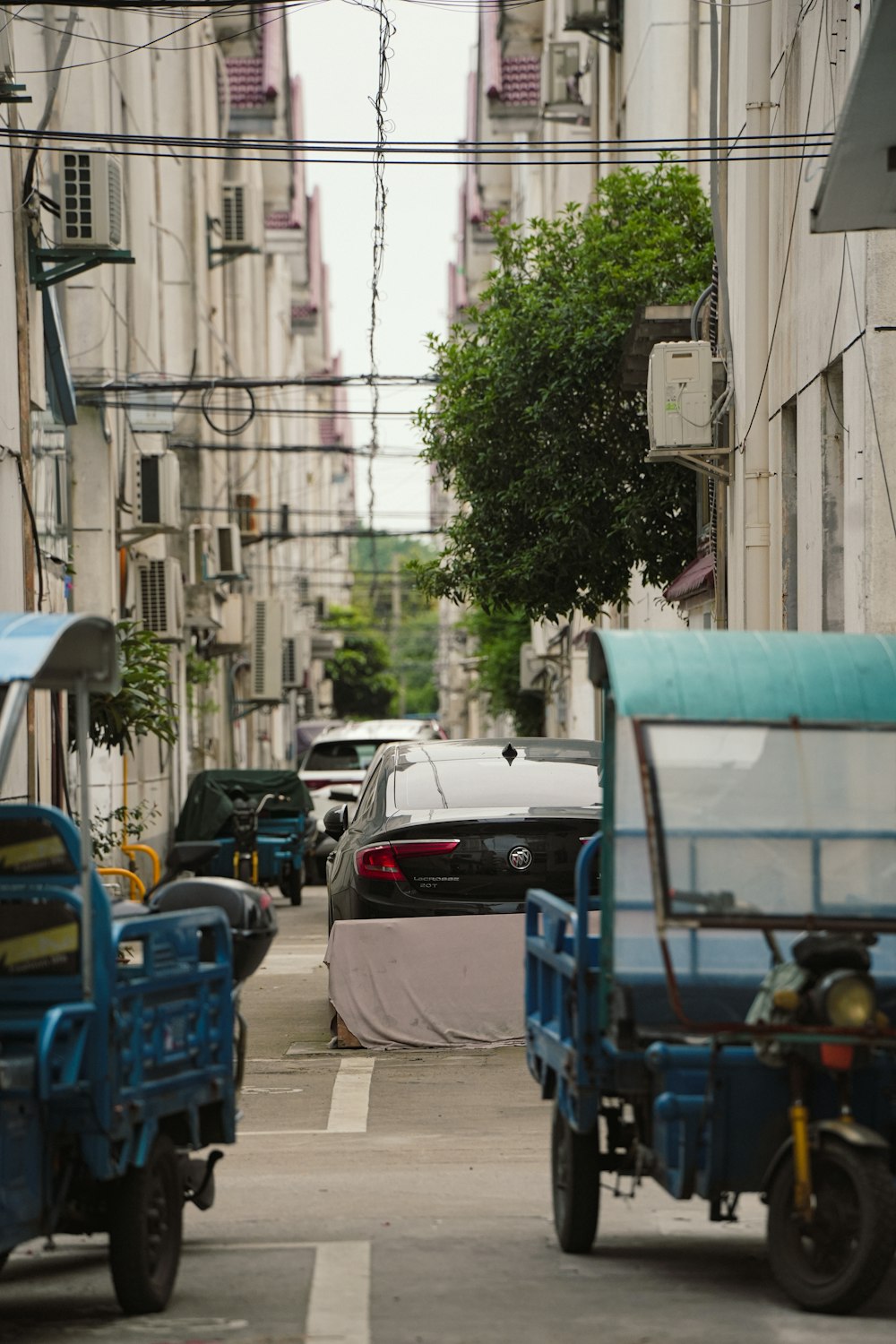 a city street filled with lots of traffic next to tall buildings