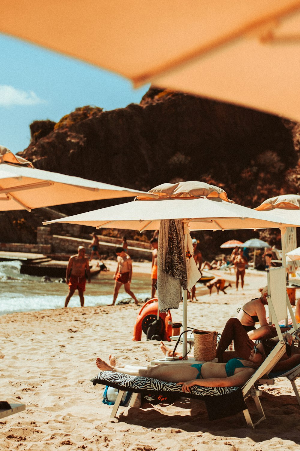 a group of people laying on top of a sandy beach