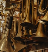 Rows of shiny brass trumpets lined up on a shelf in a cozy music shop.