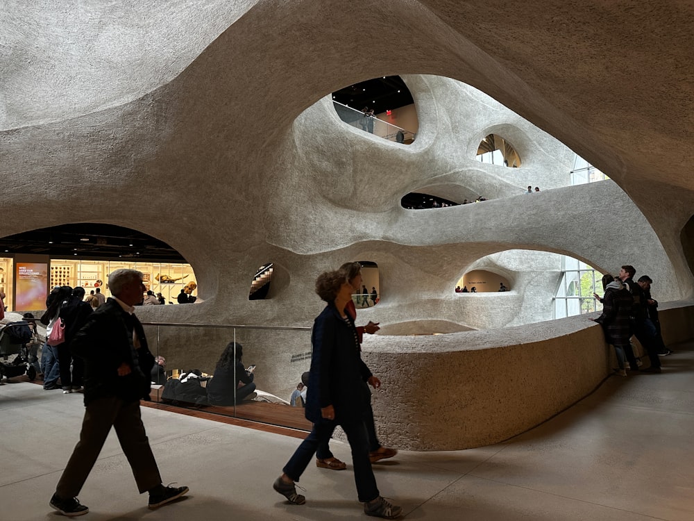 a group of people walking around a building