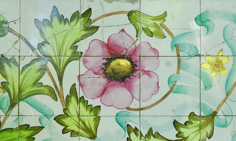a flower painted on a tiled wall