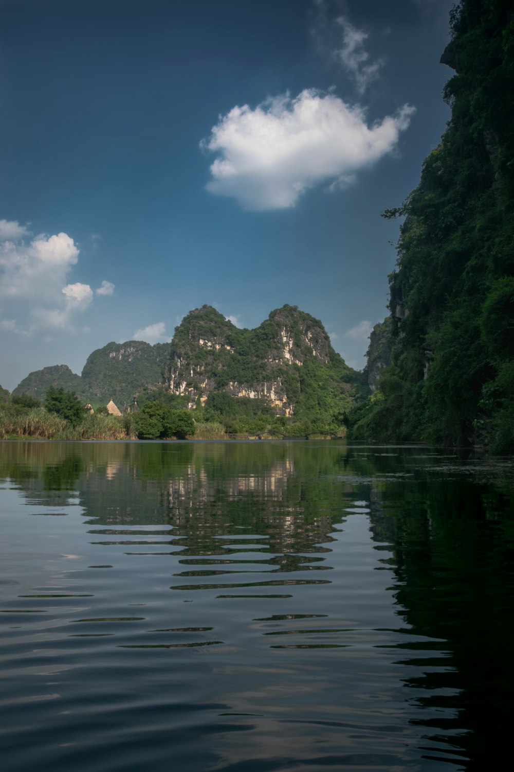 a body of water with mountains in the background