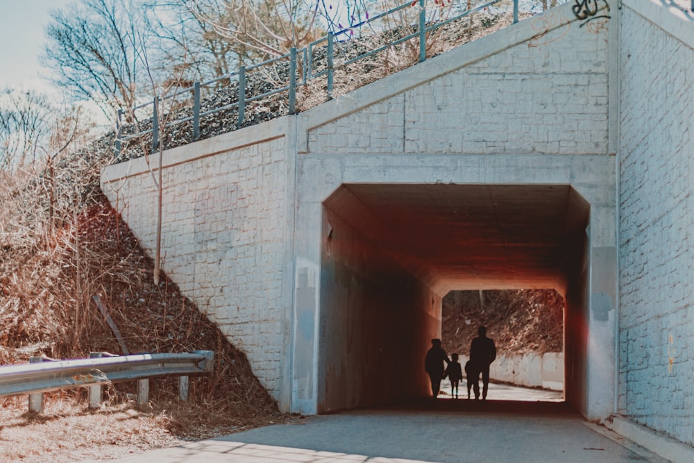 a couple of people that are standing in a tunnel