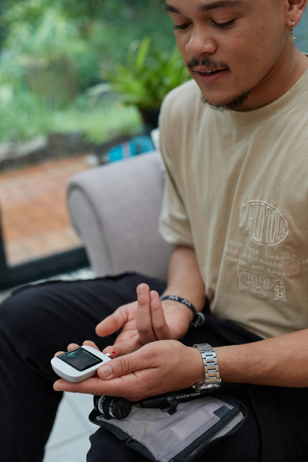 a man sitting on a couch using a cell phone