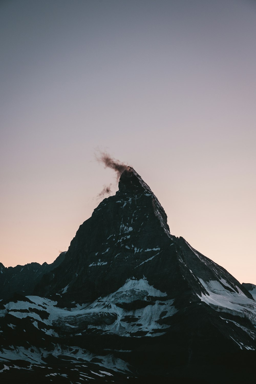 a mountain with a cloud of smoke coming out of it