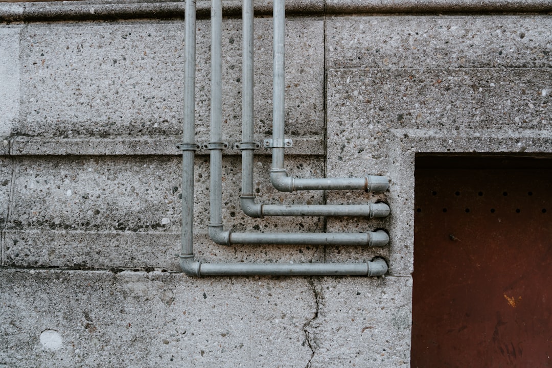 a wall with a bunch of pipes attached to it