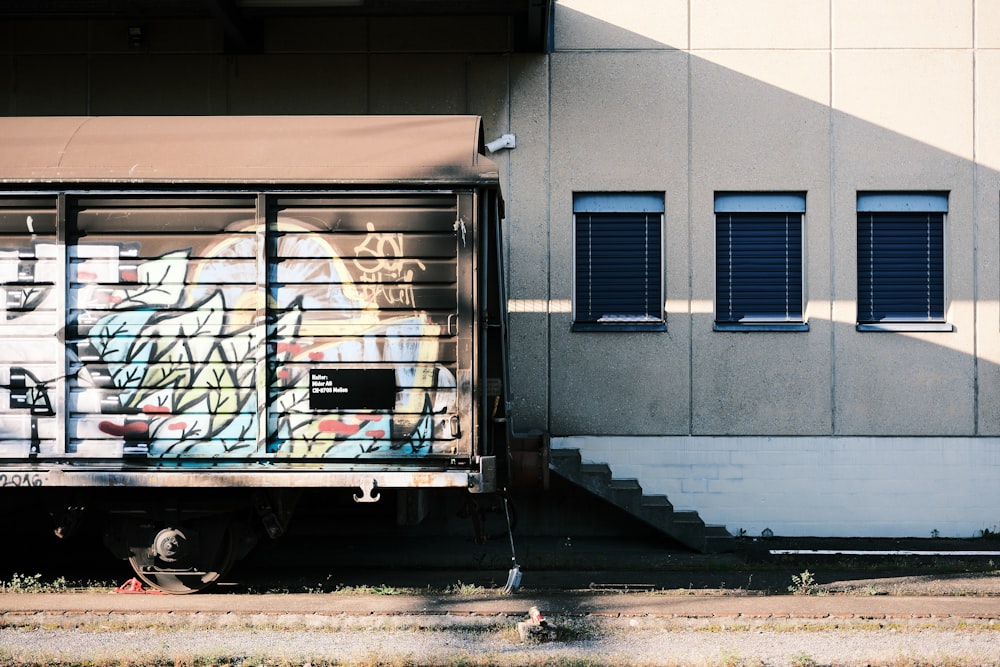 a truck parked in front of a building with graffiti on it