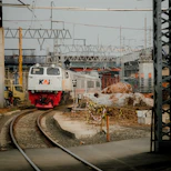 a train traveling down train tracks next to a building