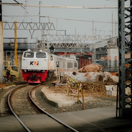 a train traveling down train tracks next to a building
