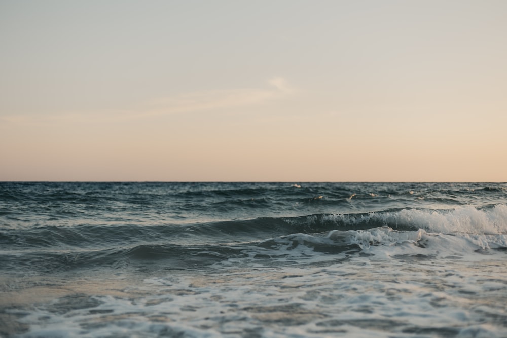 a view of a body of water with waves