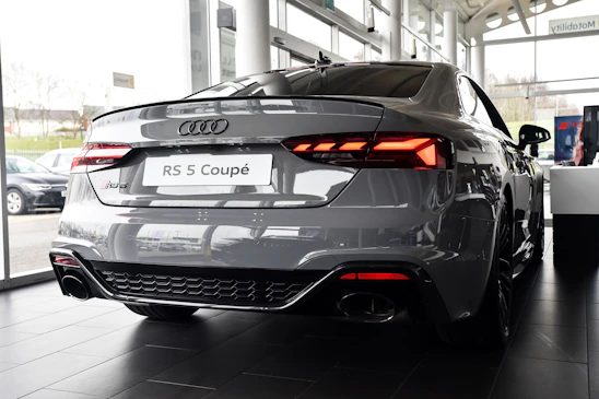 a grey car is parked in a showroom