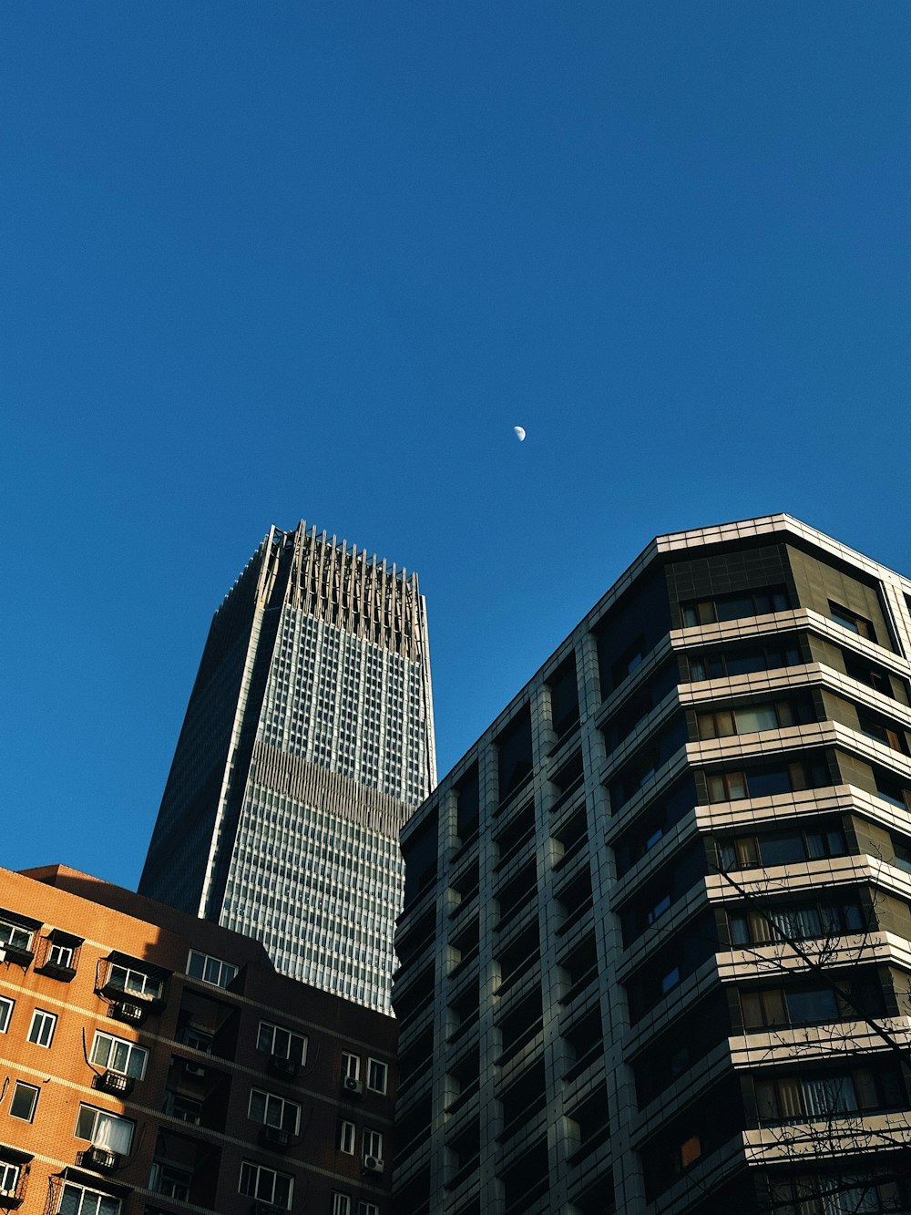 a clear blue sky with a few buildings in the foreground
