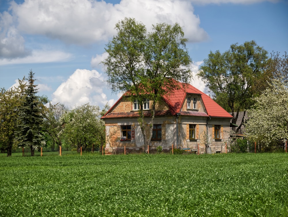 a house in the middle of a green field