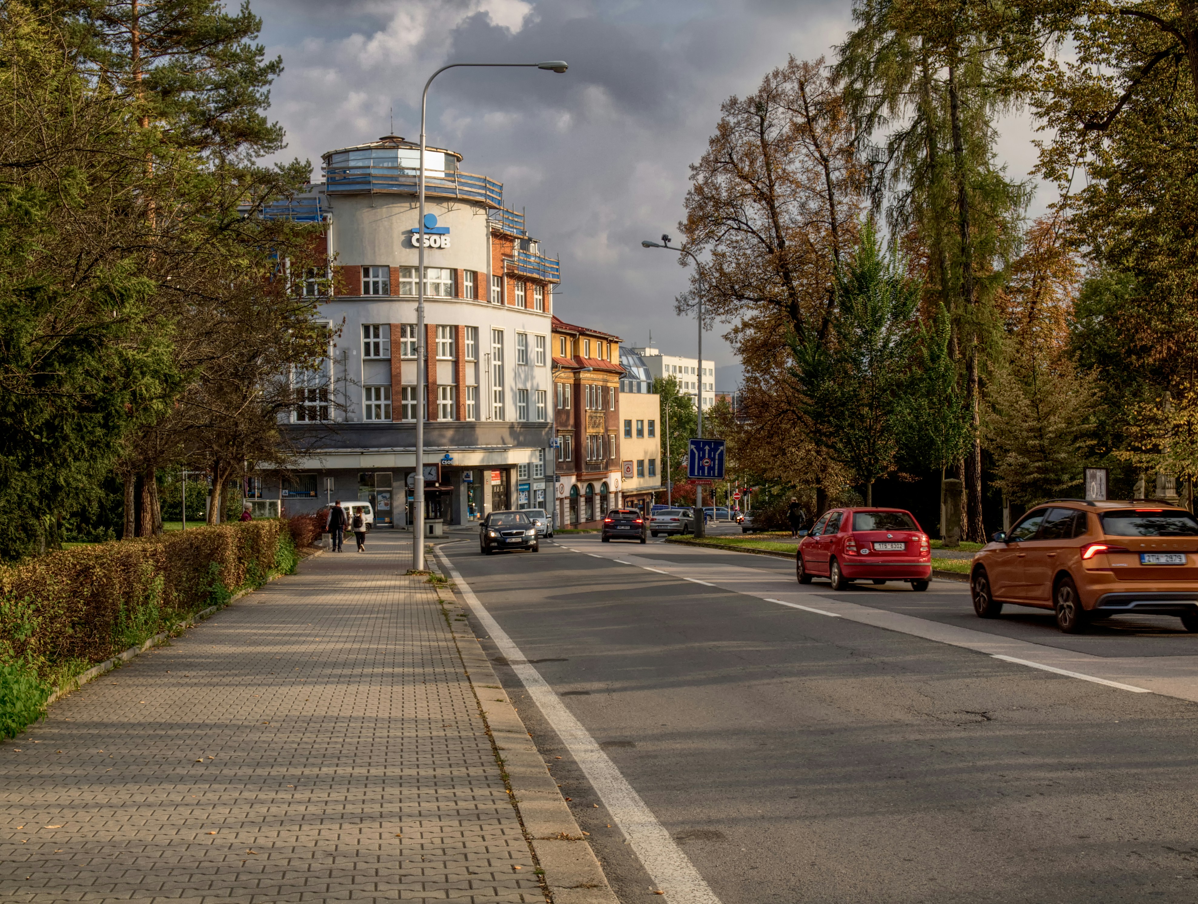 a city street with cars parked on the side of the road