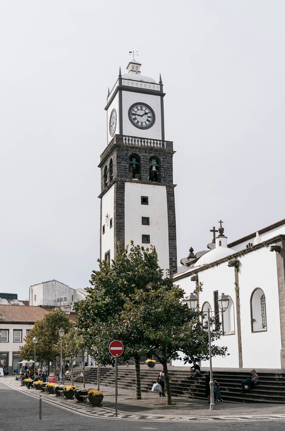 a tall clock tower with a clock on each of it's sides