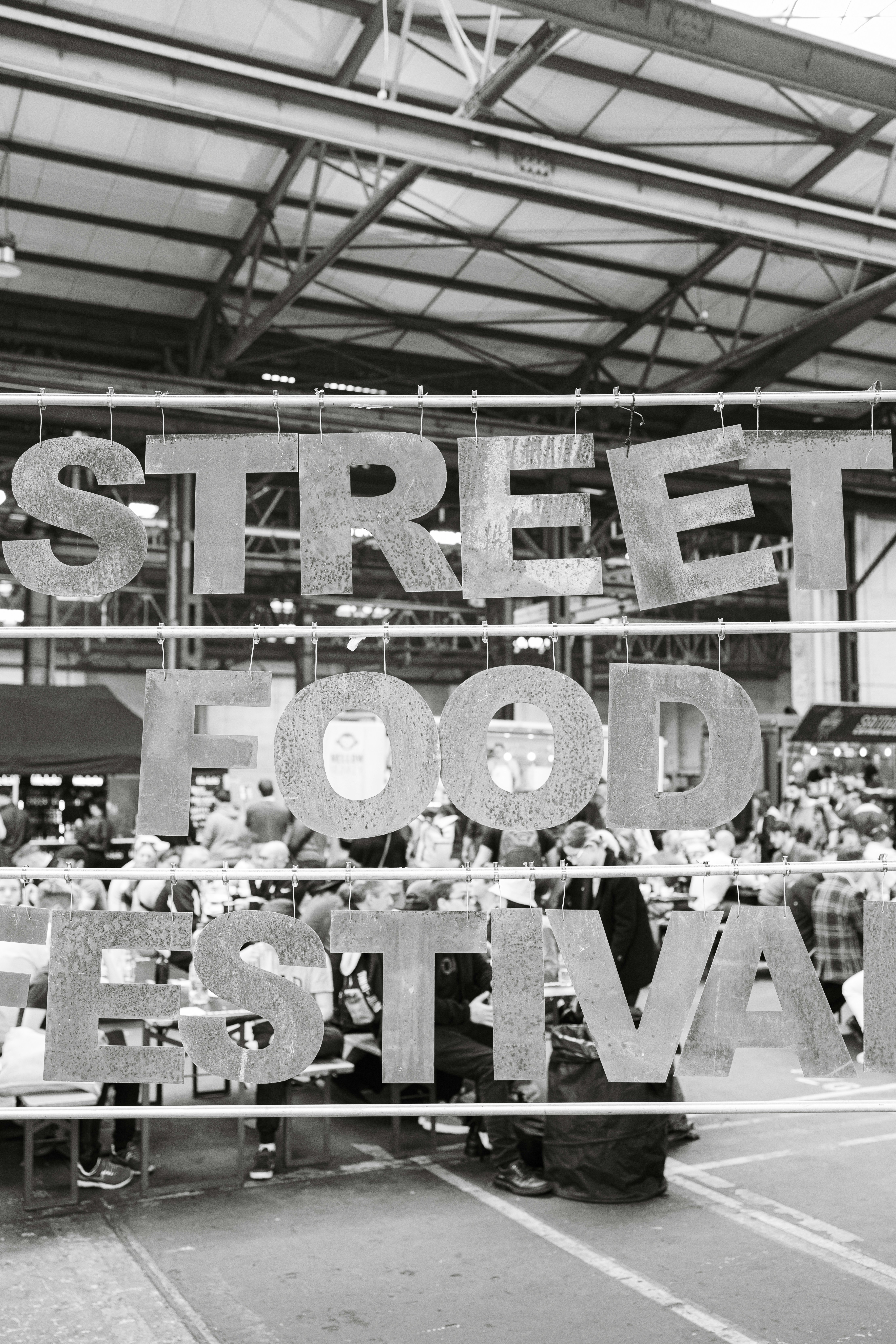 a black and white photo of a street food festival