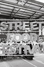 a black and white photo of a street food festival