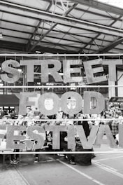 a black and white photo of a street food festival