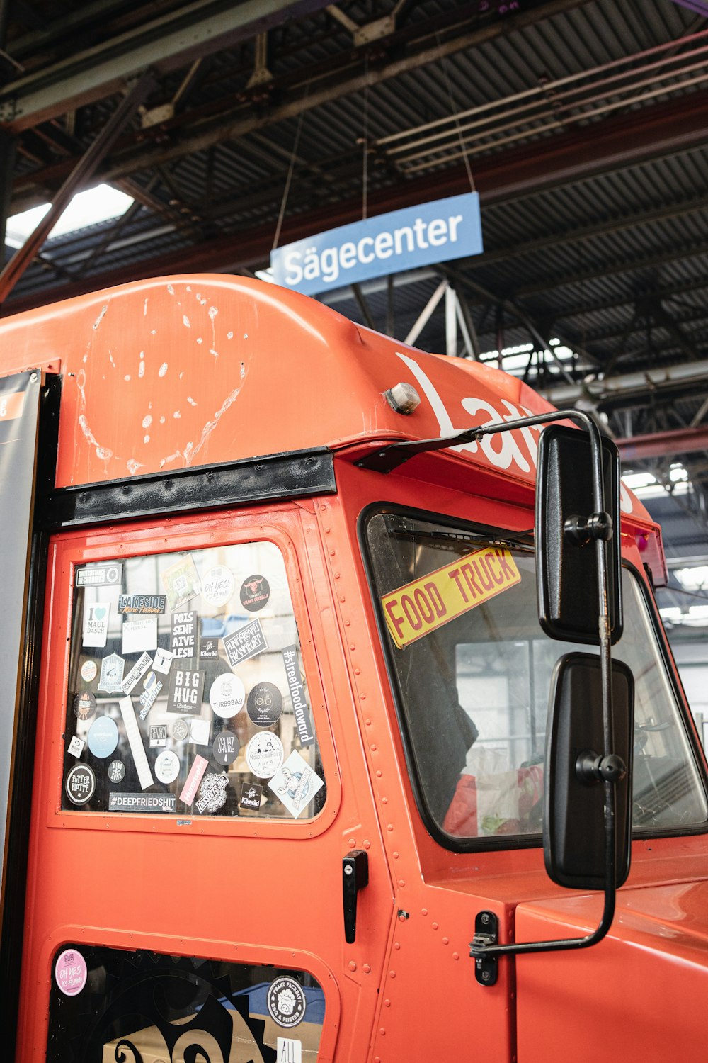 an orange truck parked inside of a building