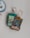 Several collectible cards, including a Spell card titled 'Crystal Bond' and a Dragon card, lie on a light surface. Nearby, there are a few polished crystals and a large, round blue geode add a natural element to the composition.