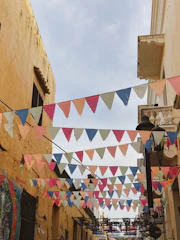 Colorful street banners and posters advertising local businesses in Mendoza.