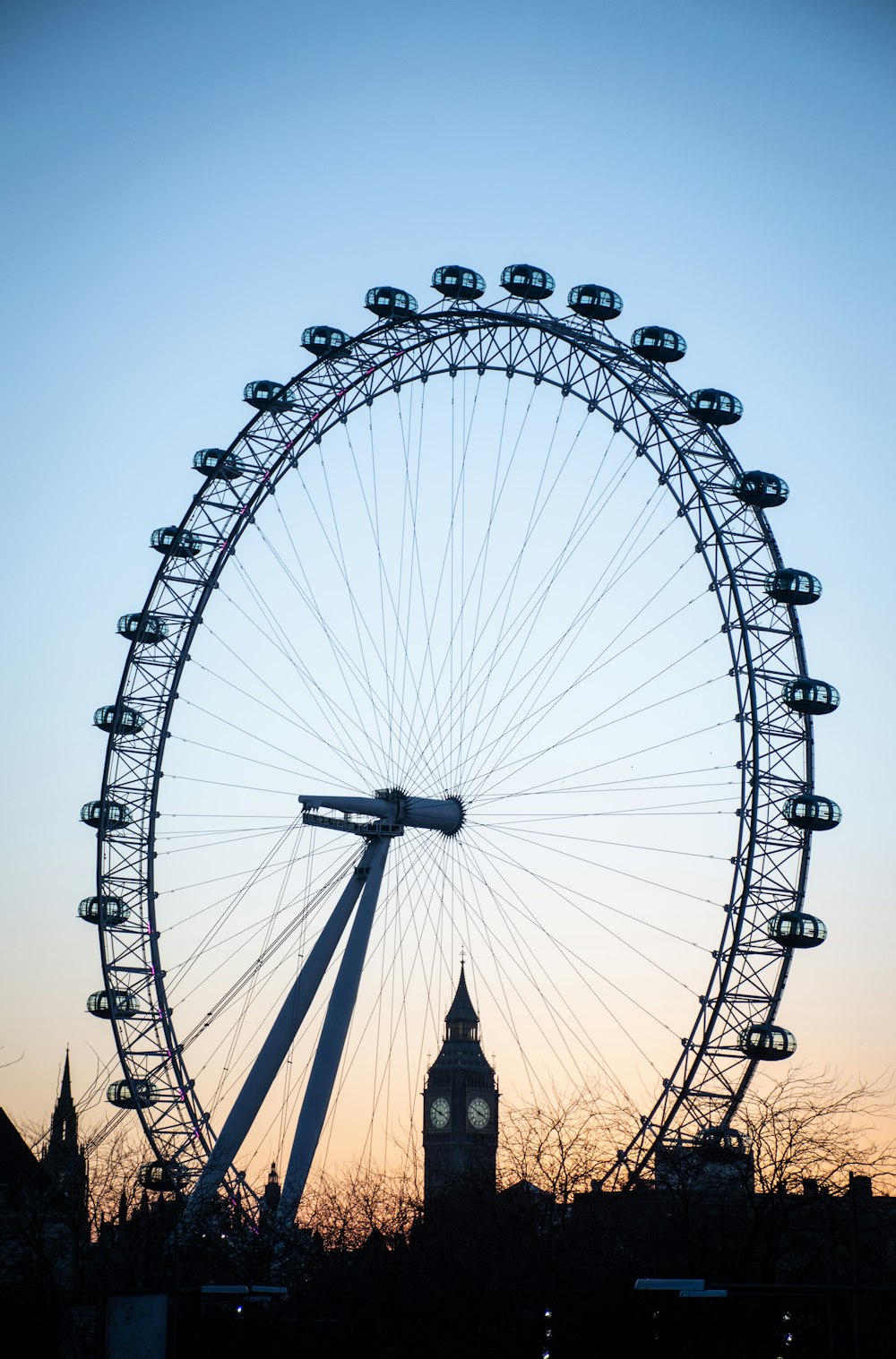 a large ferris wheel sitting next to a tall building